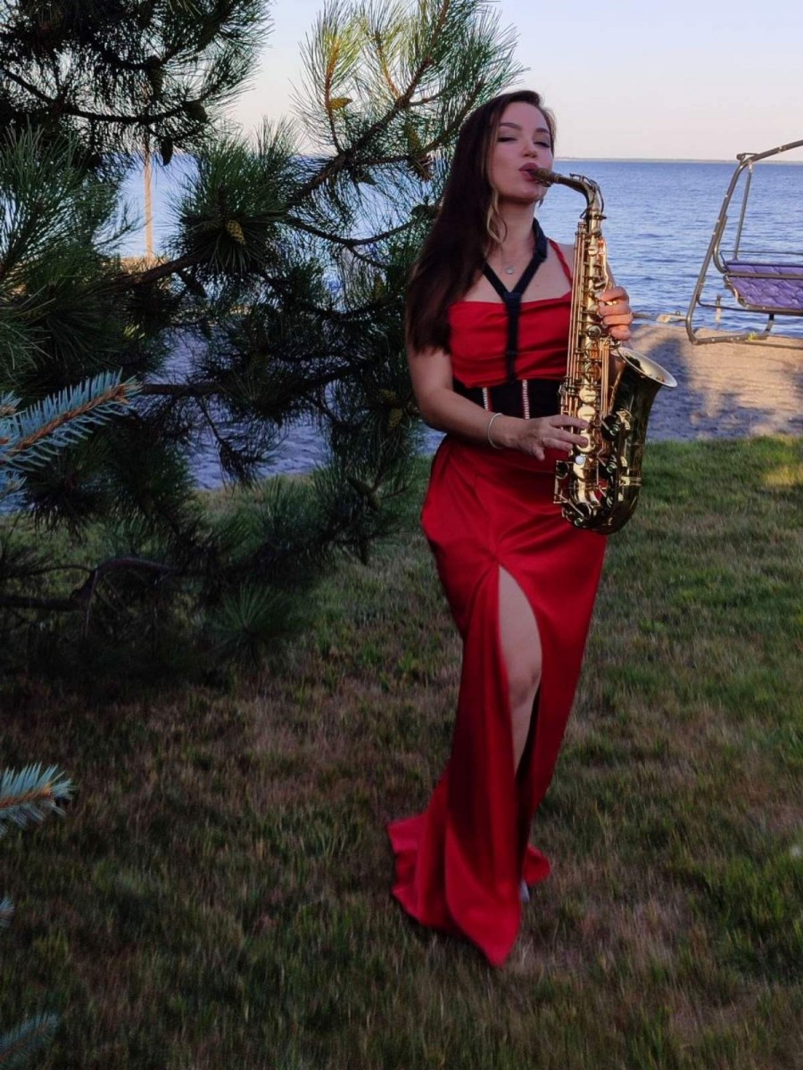 Саксофоністка Iva Sax створює атмосферу ексклюзивного приватного свята біля Київського моря, виступаючи із золотистим саксофоном серед хвойного саду